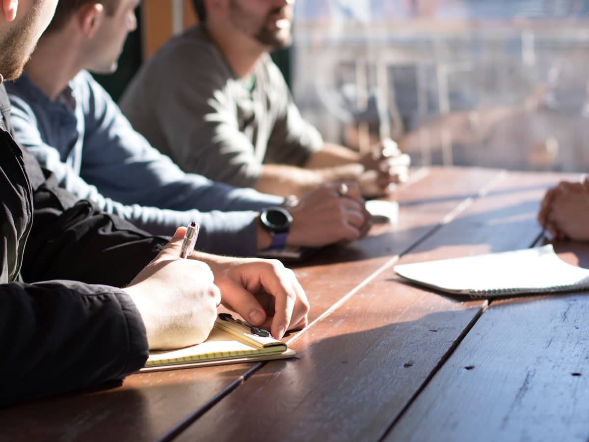 Team working through plans together around a table